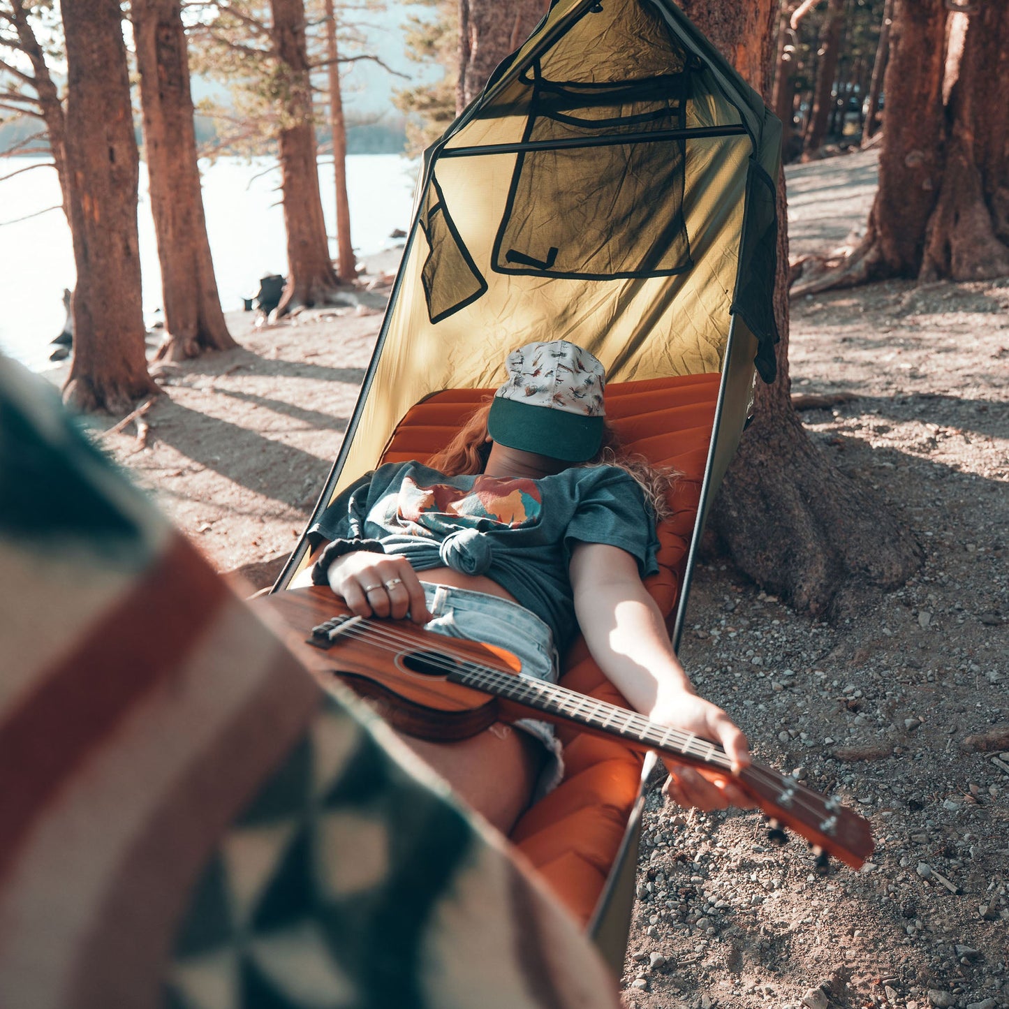 Woman sleeping outdoors in a lay flat hammock