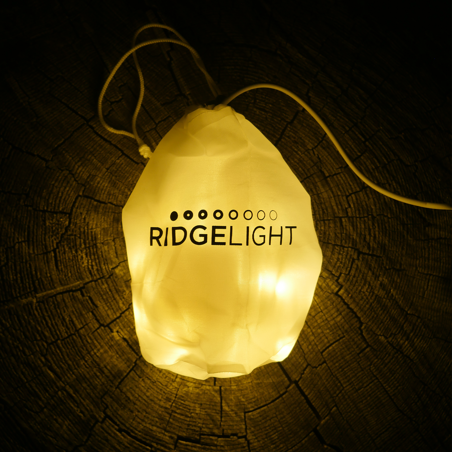 Camping hammock lights glowing from inside a bag. Camping lights