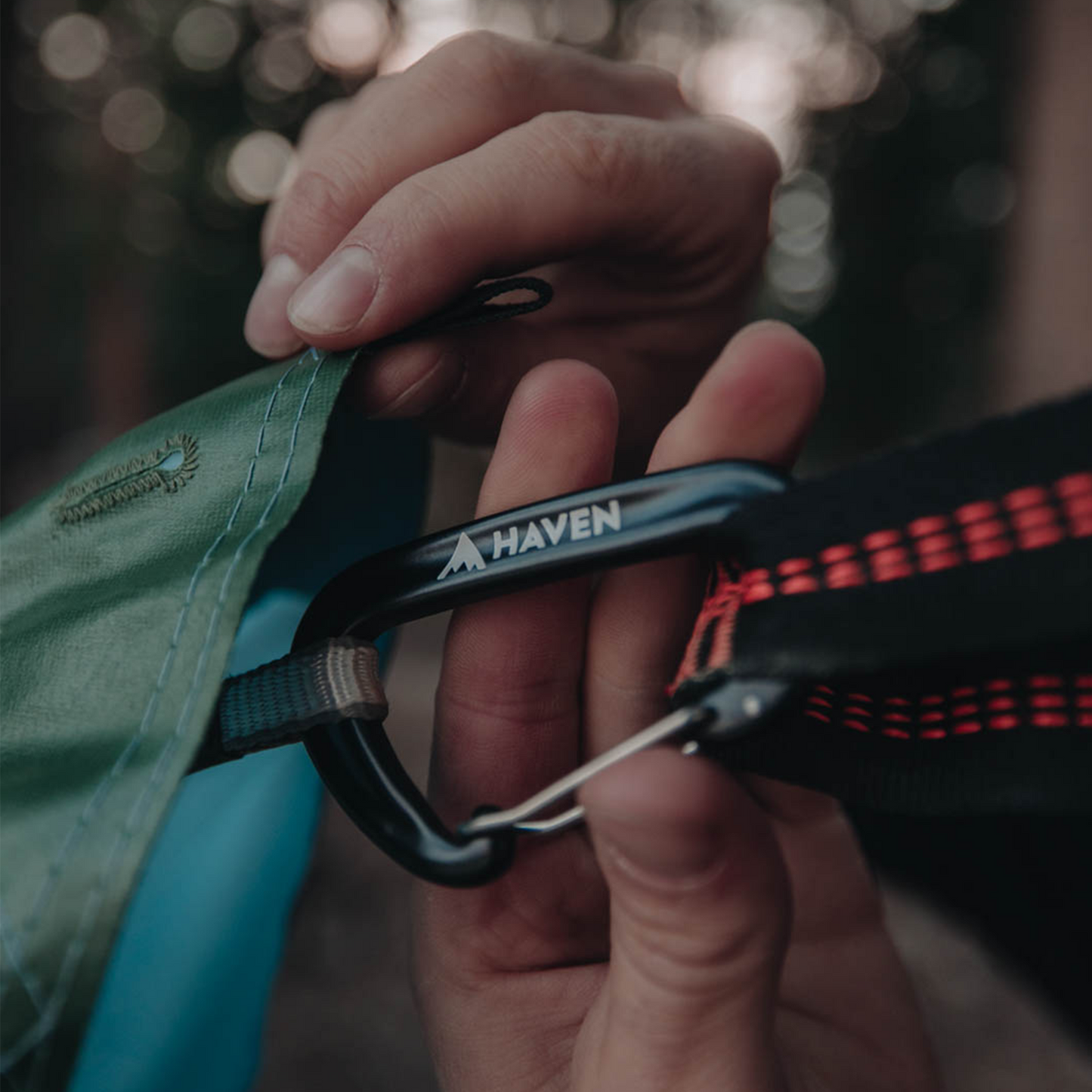 Carabiner attached to camping hammock rainfly