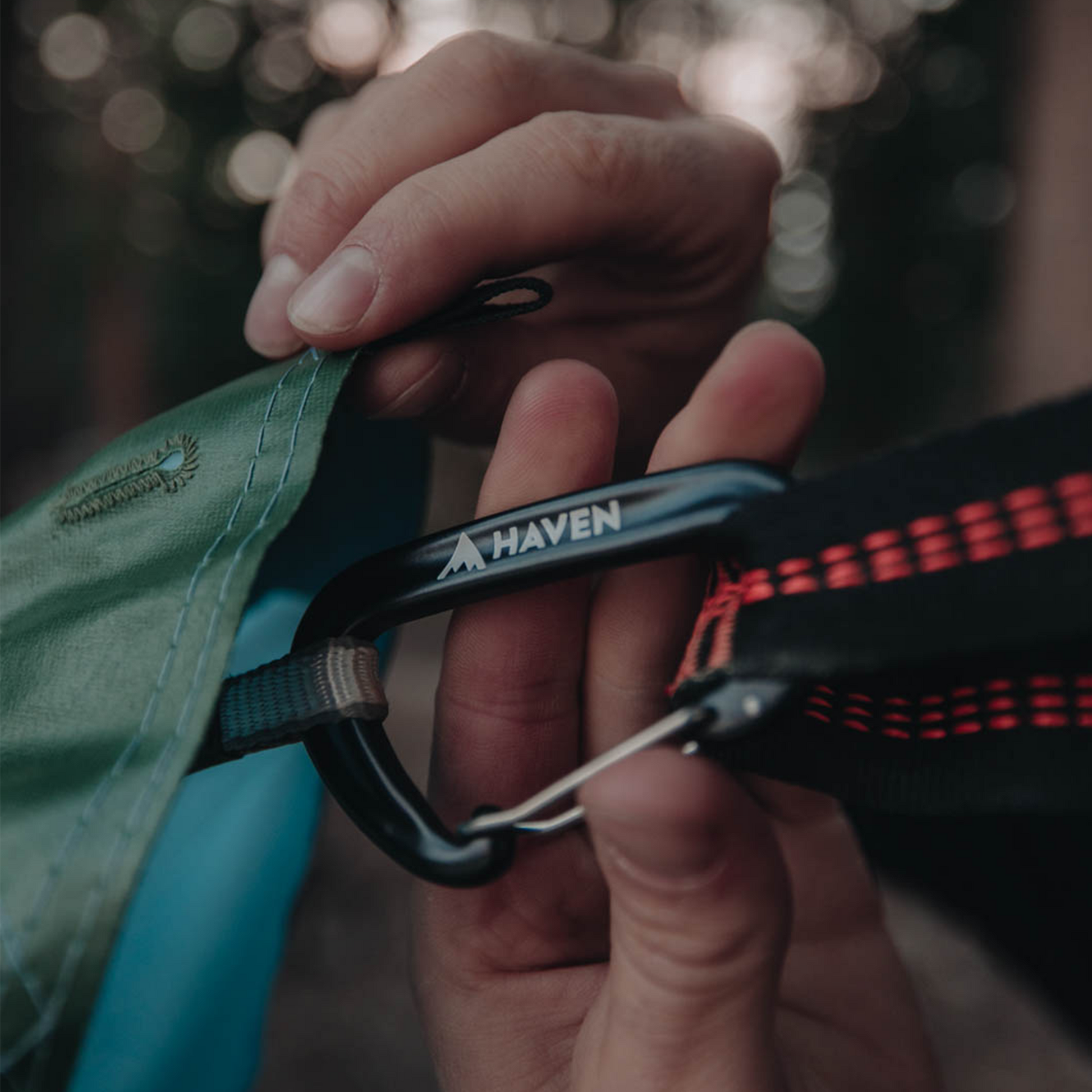 Carabiner attached to camping hammock rainfly
