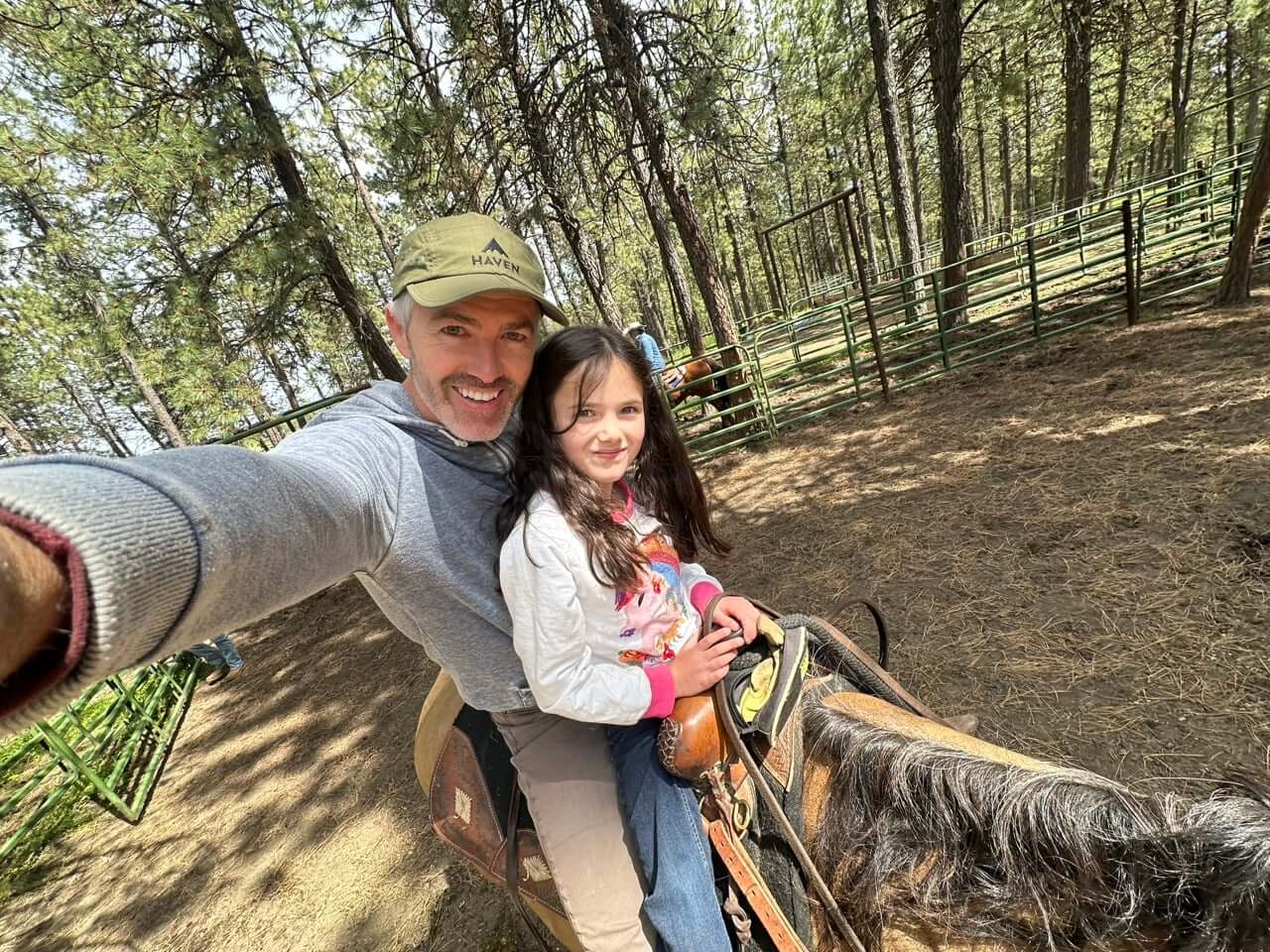Father and daughter riding a horse in Wallowa County Oregon