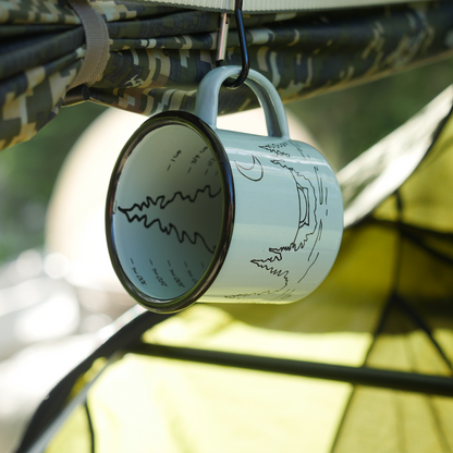 Camping mug hanging by a carabiner inside a hammock tent