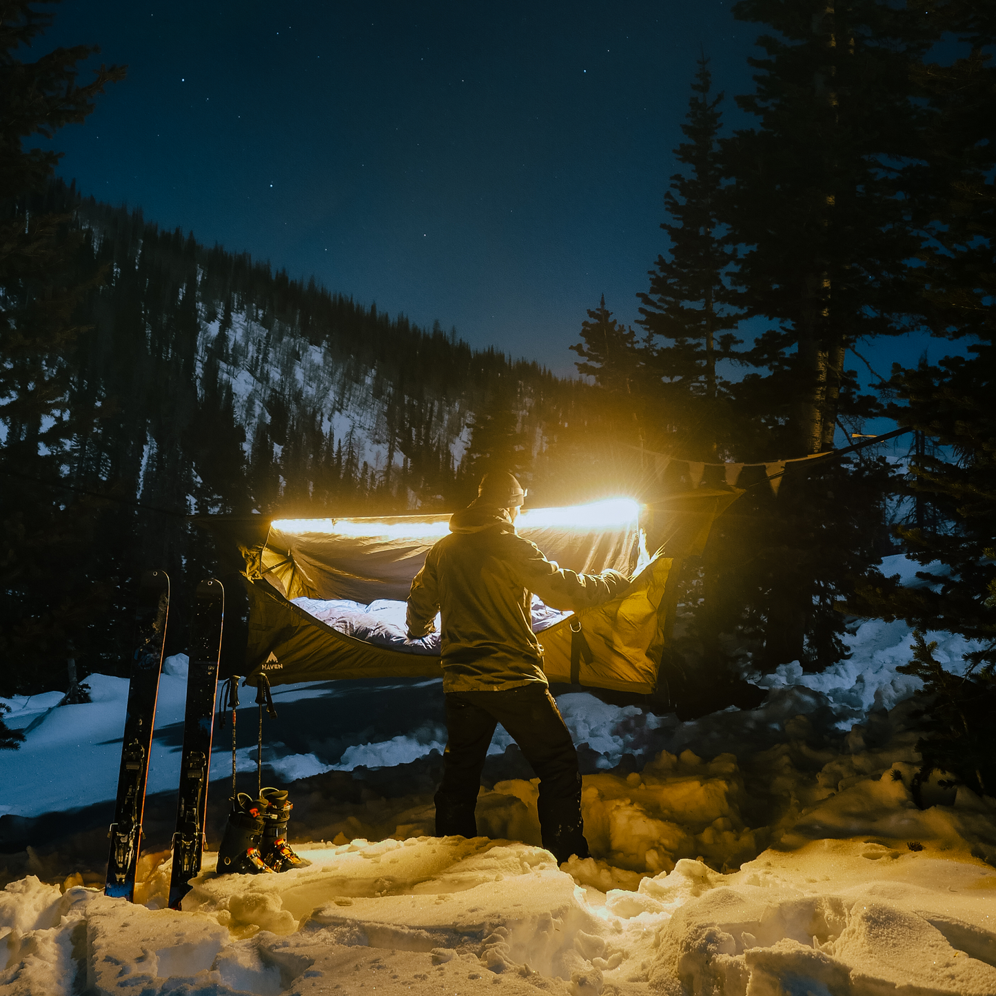 LED light string set up on camping hammock in the snow