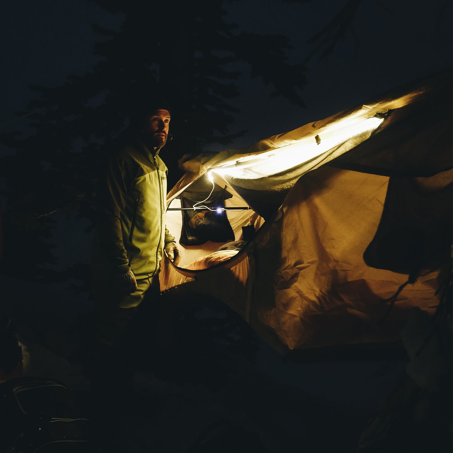 Man standing next to the best camping hammock light